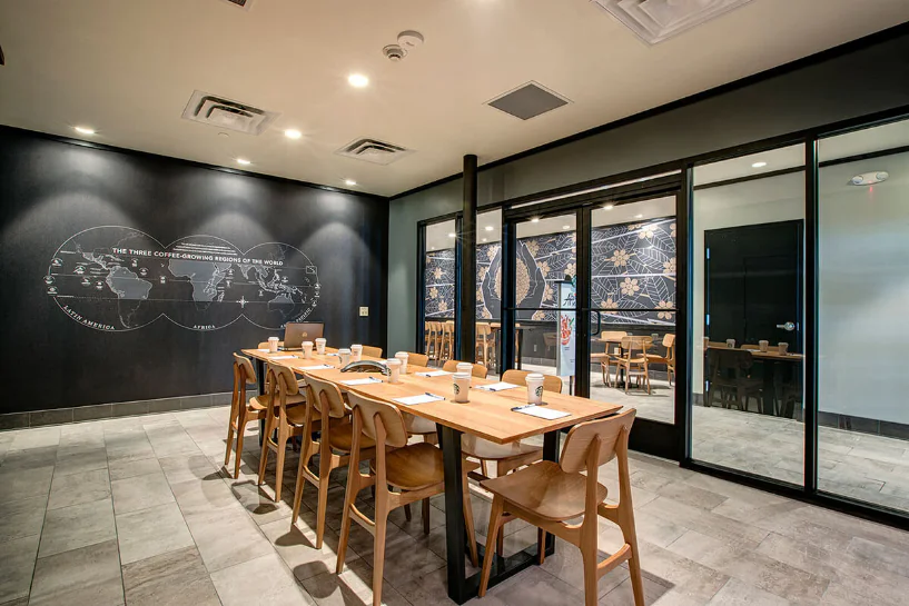 Starbucks café with a long wooden table and modern decor