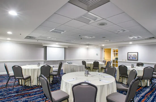 Meeting space with round tables and gray chairs