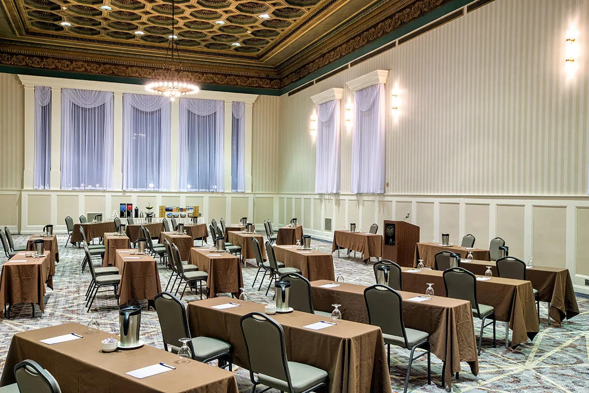 Spacious event hall with tables and chairs set up for a conference or meeting