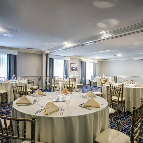Elegant banquet hall set with round tables and chairs for an event at Gettysburg Hotel.