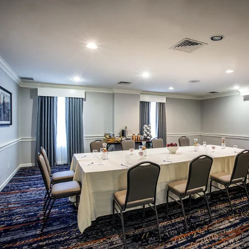 Conference room with a long table, chairs, and refreshments set up for a meeting at Gettysburg Hotel